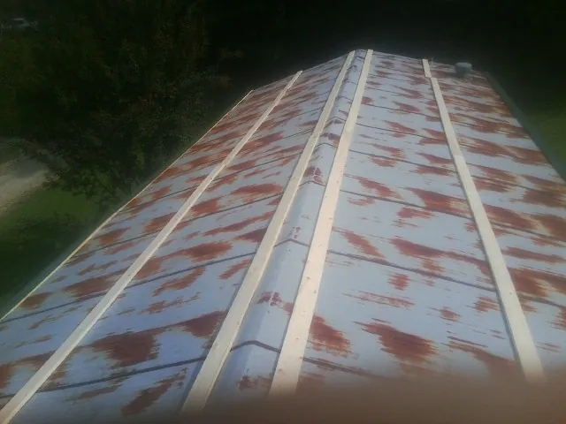 Rusted metal roof panels with new wood purlins before replacement — Storm Damage Roof Repair in Wooster by Roofing Brothers